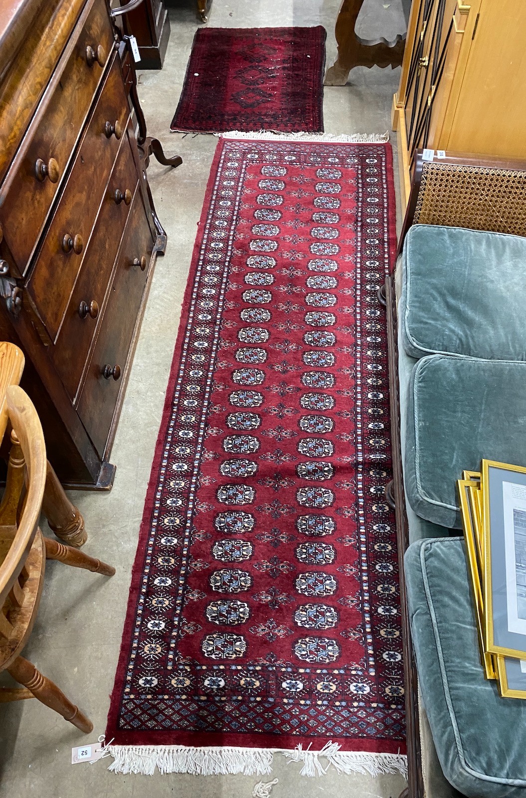 A Bokhara red ground runner and an Afghan rug, larger 250cms x 80cms.